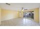 Sun-filled living room with tile floors, a ceiling fan, and a large window at 15530 Morgan St, Clearwater, FL 33760