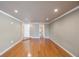 Spacious living room featuring hardwood floors, neutral walls, and recessed lighting at 15530 Morgan St, Clearwater, FL 33760