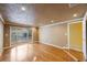 Inviting living room with hardwood floors, large window with street view, and lots of natural light at 15530 Morgan St, Clearwater, FL 33760