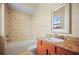 Bathroom with tiled walls, a tub and vanity with marble countertop at 15708 Oakleaf Run Dr, Lithia, FL 33547