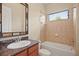 Bathroom featuring a granite vanity, toilet, and tile surround bathtub with showerhead at 15708 Oakleaf Run Dr, Lithia, FL 33547
