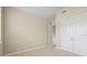 Neutral bedroom featuring a double door closet, carpeted floor, and base trim at 15708 Oakleaf Run Dr, Lithia, FL 33547