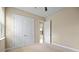 Neutral bedroom featuring double doors and an open doorway at 15708 Oakleaf Run Dr, Lithia, FL 33547