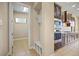 A view into the kitchen reveals modern stainless appliances and sleek cabinetry with a hallway to the side at 15708 Oakleaf Run Dr, Lithia, FL 33547