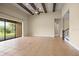 Bright living room boasts tile floors, ceiling fan, and large sliding glass doors to a view of the outdoors at 15708 Oakleaf Run Dr, Lithia, FL 33547