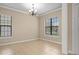 Bright, neutral living room with tile floors, large windows, and elegant chandelier at 15708 Oakleaf Run Dr, Lithia, FL 33547