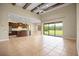 Open living space featuring a kitchen island, high ceilings, and a backyard view at 15708 Oakleaf Run Dr, Lithia, FL 33547