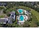 Aerial view of the community pools, showing layout, landscaping, and surrounding homes at 15912 Ternglade Dr, Lithia, FL 33547