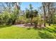 Lush landscaping with a variety of plants and flowers surrounding the lawn at 15912 Ternglade Dr, Lithia, FL 33547