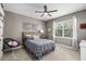 Comfortable bedroom with ceiling fan, queen bed, and large window at 15912 Ternglade Dr, Lithia, FL 33547