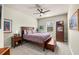 Cozy bedroom featuring a ceiling fan, a large window and an area rug at 15912 Ternglade Dr, Lithia, FL 33547