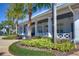 Elegant clubhouse features stately white columns, a covered porch, and meticulous landscaping at 15912 Ternglade Dr, Lithia, FL 33547