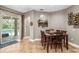 Cozy dining area featuring a stylish table set, wine rack, and sliding glass doors leading to the pool at 15912 Ternglade Dr, Lithia, FL 33547
