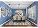 Stylish dining room with blue accent wall, modern lighting, and seating for six at 15912 Ternglade Dr, Lithia, FL 33547