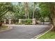Gated community entrance with stone pillars, manicured landscaping, and a welcoming atmosphere at 15912 Ternglade Dr, Lithia, FL 33547