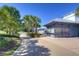 A path leads to the clubhouse patio with tables, seating, and mature palm trees at 15912 Ternglade Dr, Lithia, FL 33547