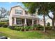 Charming two-story home featuring a stone facade, covered porch with stately columns, and beautifully landscaped front yard at 15912 Ternglade Dr, Lithia, FL 33547