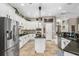 Bright and airy kitchen featuring white cabinets, granite countertops, and stainless steel appliances at 15912 Ternglade Dr, Lithia, FL 33547