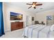 Spacious main bedroom featuring a king-size bed, dresser, and a large wall-mounted TV at 15912 Ternglade Dr, Lithia, FL 33547