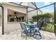 Enclosed outdoor patio with dining set and bar overlooking the interior of the home at 15912 Ternglade Dr, Lithia, FL 33547