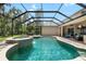 Beautiful screened-in pool with a waterfall feature and plenty of space for outdoor seating and entertaining at 15912 Ternglade Dr, Lithia, FL 33547
