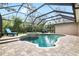 Beautiful screened-in pool with a spa and lush landscaping at 15912 Ternglade Dr, Lithia, FL 33547