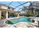 The backyard features a screened-in pool, patio, and spa, creating a private outdoor oasis for relaxation and recreation at 15912 Ternglade Dr, Lithia, FL 33547