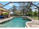 Stunning screened-in pool with spa, outdoor kitchen, covered patio, and lush greenery for privacy at 15912 Ternglade Dr, Lithia, FL 33547