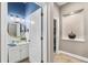 Stylish powder room featuring a round mirror and custom lighting at 15912 Ternglade Dr, Lithia, FL 33547
