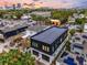 Aerial view of a neighborhood with modern homes featuring solar panels and green trees at 1627 9Th N Ave, St Petersburg, FL 33713