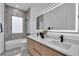 Bathroom with double sink vanity, oversized illuminated mirror, and marble backsplash at 1627 9Th N Ave, St Petersburg, FL 33713
