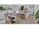 Dining area featuring an open kitchen with stainless steel appliances, a quartz countertop and modern wood cabinets at 1627 9Th N Ave, St Petersburg, FL 33713