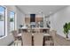 Dining area leading into a kitchen with wood cabinets, stainless steel appliances and a quartz countertop at 1627 9Th N Ave, St Petersburg, FL 33713