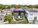 Aerial view of modern home with well manicured front yard landscaping and fenced yard at 1627 9Th N Ave, St Petersburg, FL 33713