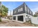 This modern home features a two-car garage with black doors and a white and black facade at 1627 9Th N Ave, St Petersburg, FL 33713