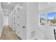 Bright hallway featuring wood floors, white doors, and natural light from the windows at 1627 9Th N Ave, St Petersburg, FL 33713