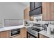Well-equipped kitchen with stainless steel appliances, modern cabinets, and stylish fixtures, perfect for cooking at 1627 9Th N Ave, St Petersburg, FL 33713