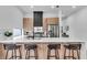 Modern kitchen with stainless steel appliances, quartz countertops, wood cabinets, and sleek black accents at 1627 9Th N Ave, St Petersburg, FL 33713