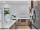 Contemporary kitchen featuring wood cabinets, a quartz countertop, modern appliances and a stainless steel refrigerator at 1627 9Th N Ave, St Petersburg, FL 33713