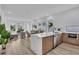 Open-concept living space with kitchen island, dining area, and comfortable seating, bathed in natural light at 1627 9Th N Ave, St Petersburg, FL 33713