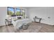 Stylized main bedroom featuring a comfortable king-size bed, area rug, and three large windows at 1627 9Th N Ave, St Petersburg, FL 33713