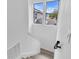 Staircase with white walls and views of the outside through large windows at 1627 9Th N Ave, St Petersburg, FL 33713