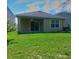 Exterior photo of backyard and covered patio of home at 17014 Oval Rum Dr, Wimauma, FL 33598