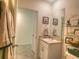 Bathroom vanity featuring granite counters, artwork, with neutral walls and tile floors at 17014 Oval Rum Dr, Wimauma, FL 33598