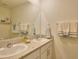 Bathroom featuring double sinks with granite countertops at 17014 Oval Rum Dr, Wimauma, FL 33598