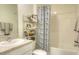 Well-lit bathroom features a shower and tub, complemented by a stylish vanity and storage shelving at 17014 Oval Rum Dr, Wimauma, FL 33598