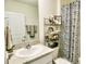 Bright bathroom with granite counters, artwork, and white vanity cabinet at 17014 Oval Rum Dr, Wimauma, FL 33598