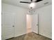 Neutral bedroom with ceiling fan, neutral walls and carpet, and multiple doors at 17014 Oval Rum Dr, Wimauma, FL 33598