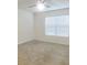An empty bedroom with neutral walls, carpet, and blinds at 17014 Oval Rum Dr, Wimauma, FL 33598