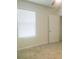 Bedroom featuring a ceiling fan and large window with blinds at 17014 Oval Rum Dr, Wimauma, FL 33598